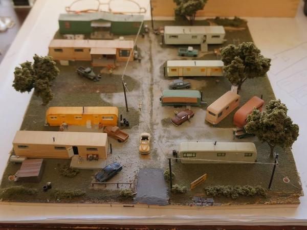 a miniature model of a rv park with cars, trucks and campers in it