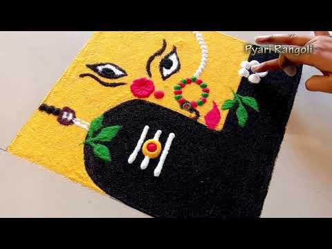 someone is painting the face of a black cow on a yellow rug with beads and flowers