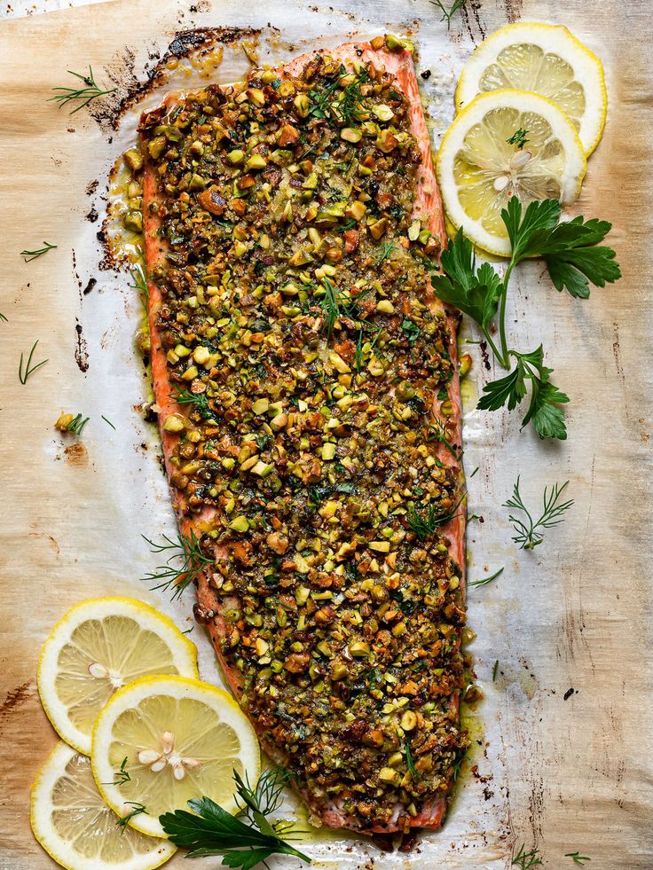 salmon with herbs and lemons on a cutting board