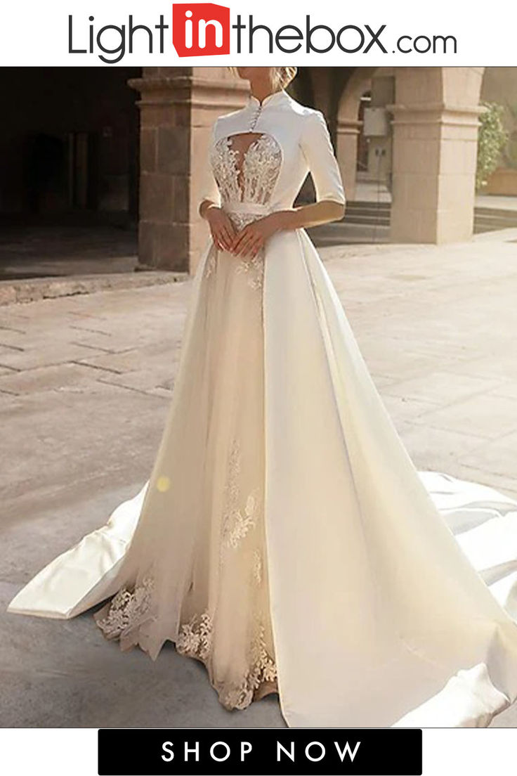 a woman in a wedding dress standing outside