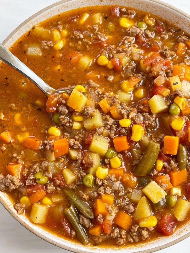 a white bowl filled with soup and vegetables