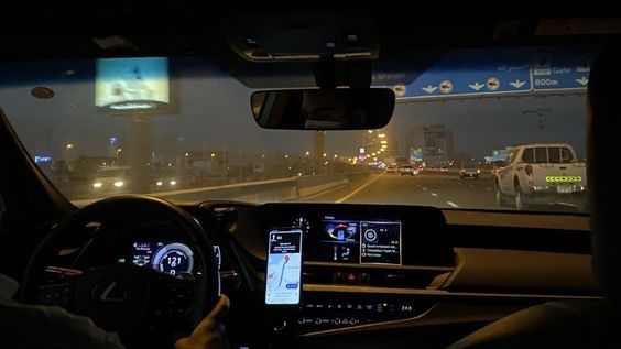 a man driving a car at night on the highway