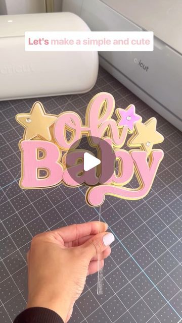 someone is holding up a wooden cutout that says baby and stars on the top