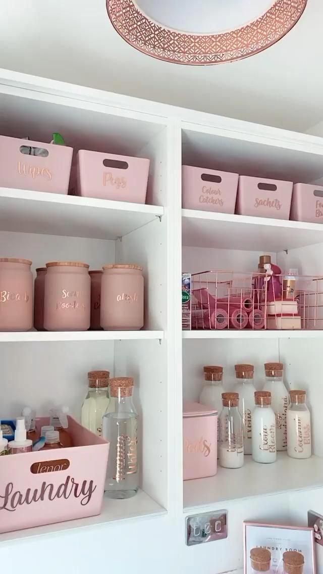 the shelves are filled with pink containers and other bathroom items, such as soaps