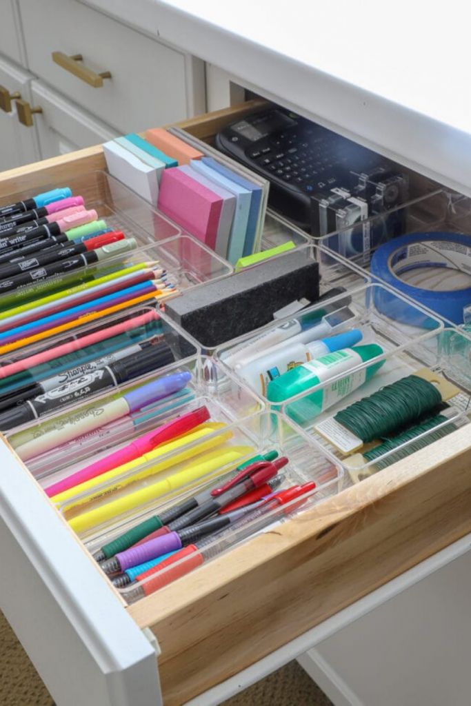 an organized drawer with pens, markers and pencils