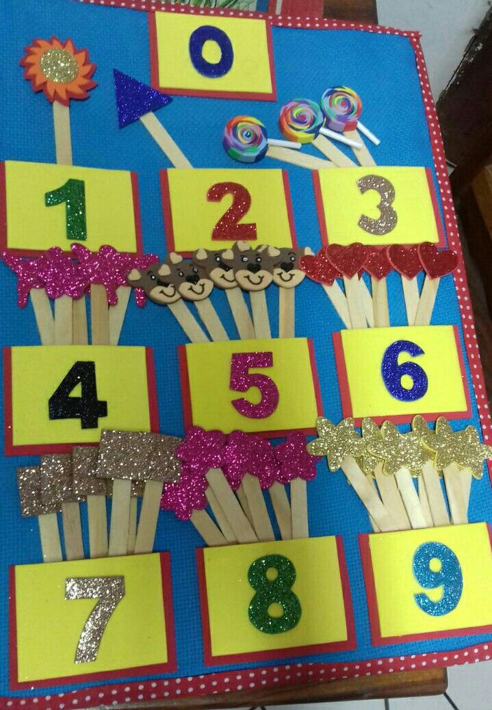 a table topped with lots of cupcakes and numbers