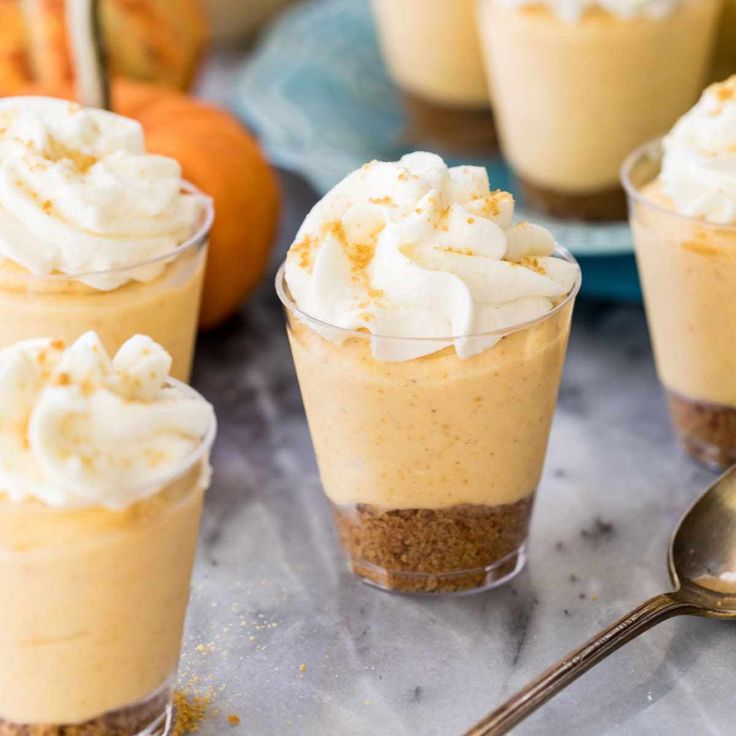 small desserts with whipped cream and pumpkins in the background