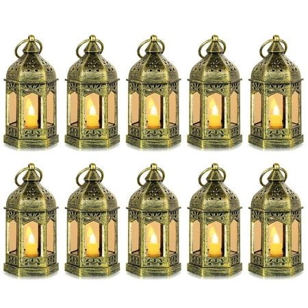 eight brass lanterns with candles in them