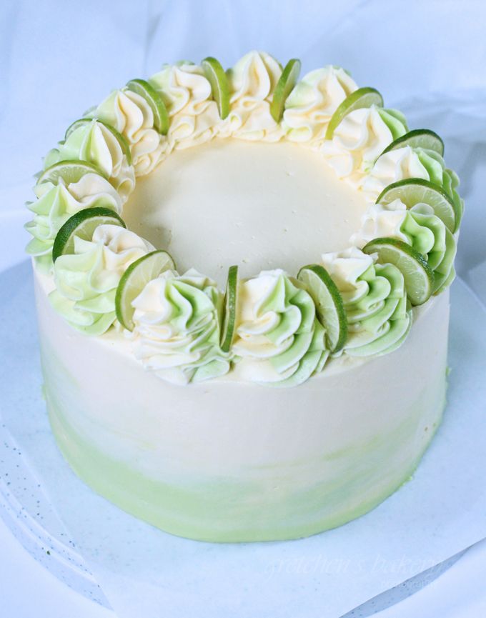 a cake with white frosting and green decorations