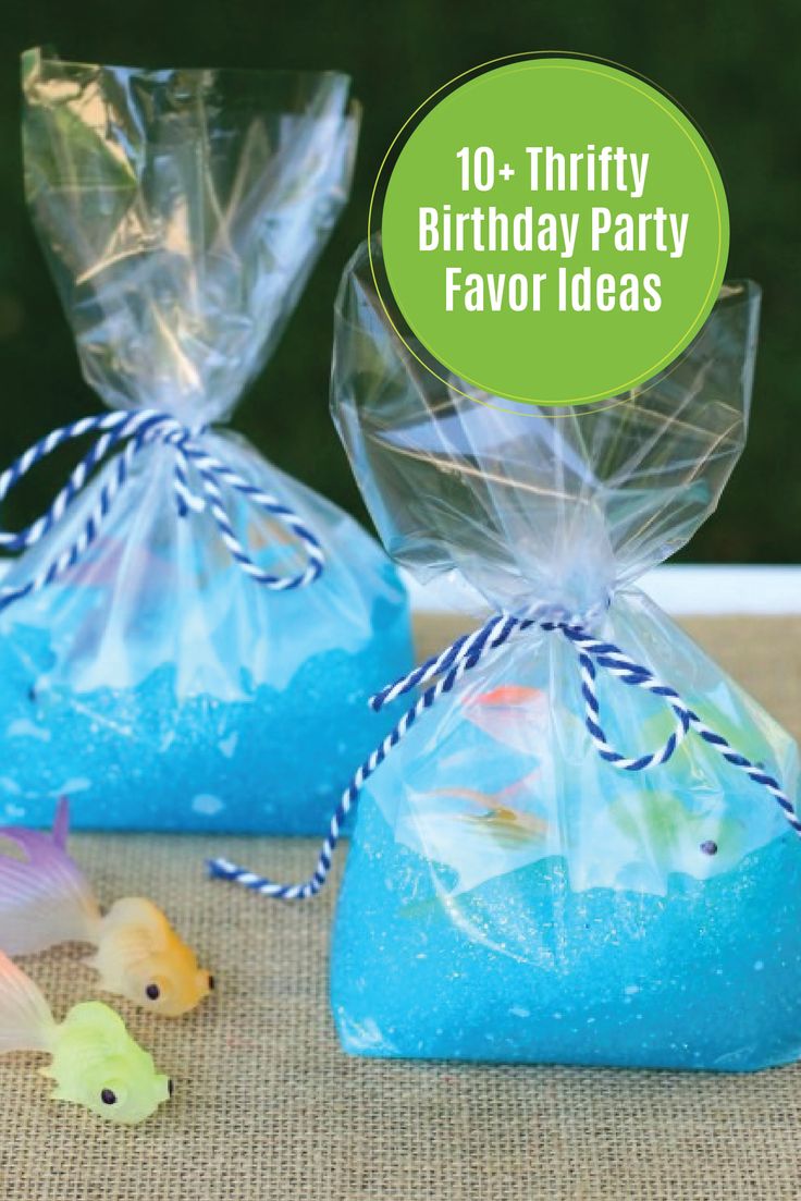 two bags filled with blue soap sitting on top of a table next to small plastic toys