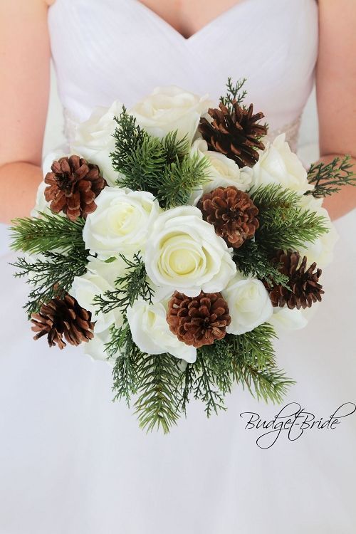 a bridal bouquet with pine cones and white roses