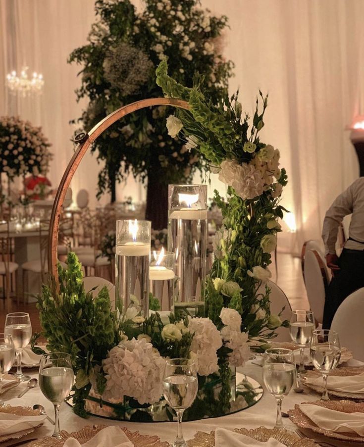 the centerpiece is surrounded by candles and flowers