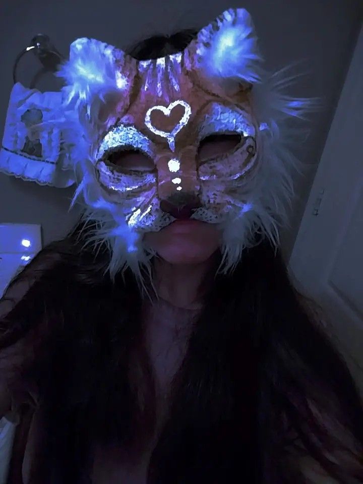 a woman wearing a cat mask with lights on her face