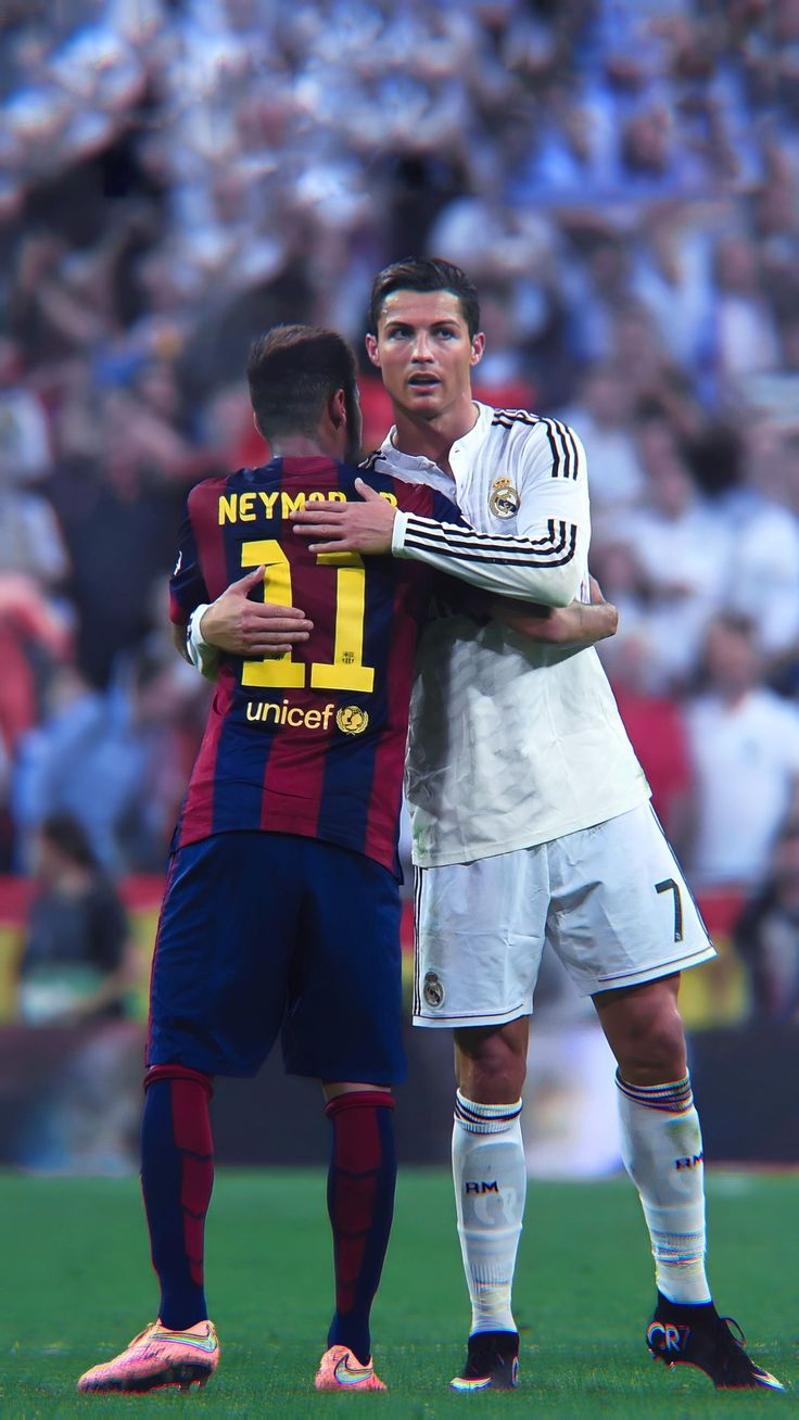 two soccer players embracing each other on the field