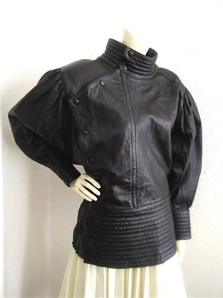 80s extravagant leather jacket, dolman sleeve, black leather jacket, very high waist jacket, batwing puffy sleeve jacket, quilted elasticated waist, asymmetric closure jacket high cuffs, no label size. The jacket is very beautiful, is not dry clean. have two small scratches, barely visible on the chest, and also another one on the back. Even the jacket have those very small sign of wear, the jacket is beautiful, extravagant and spectacular. measurements lying flat : shoulders and both sleeves together :173 cm (68 inches) bust :60 cm (23,5 inches) waist :41 cm (16 inches) high waist :20 cm (8 inches) total length :65 cm (25.5 inches) Waist Jacket, Archive Fashion, Couture Designers, Satin Jackets, Sleeve Jacket, Leather Outfit, Black Leather Jacket, Historical Fashion, Dolman Sleeve