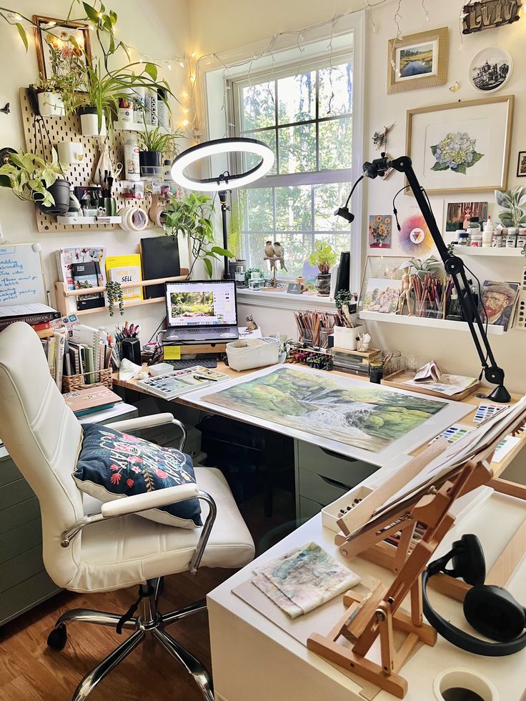 a home office with lots of art on the desk