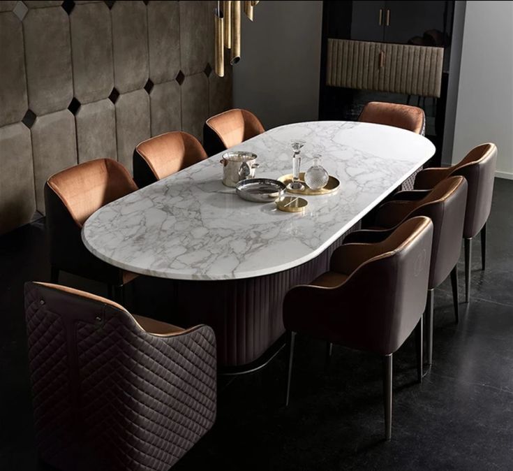 a dining table with chairs around it and a chandelier hanging from the ceiling