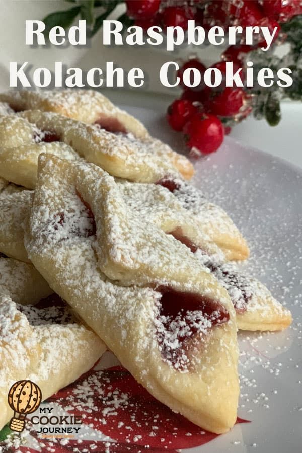 red raspberry kolache cookies on a white plate with powdered sugar