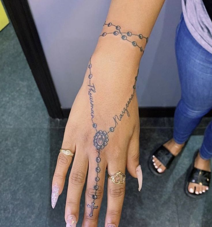 a woman's hand with tattoos on it