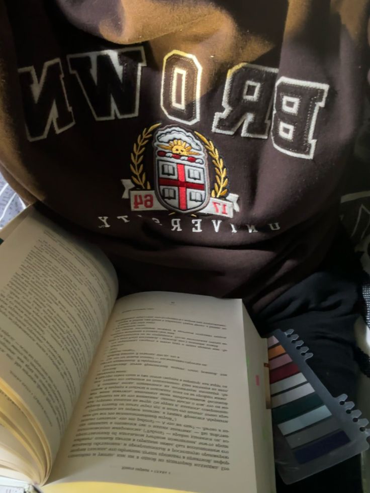 an open book sitting on top of a pile of books