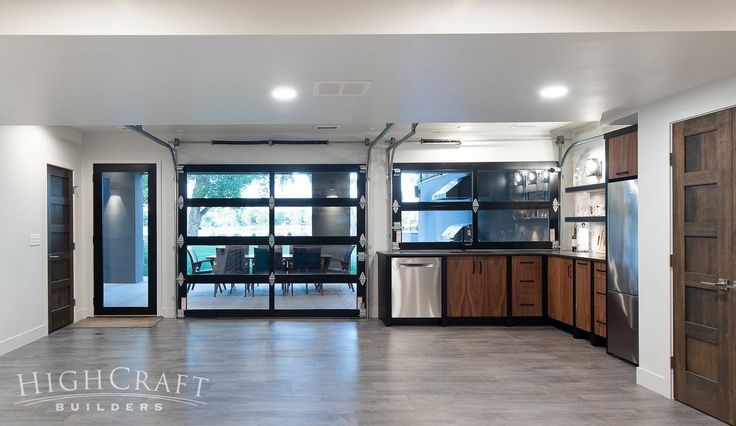 an empty kitchen with wooden cabinets and stainless steel appliances in the middle of the room