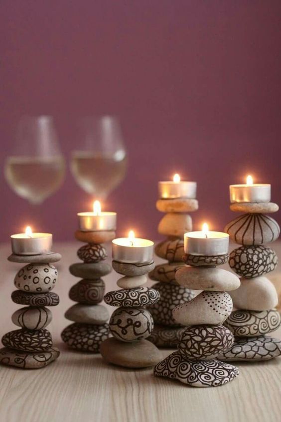 candles and rocks with wine glasses in the background