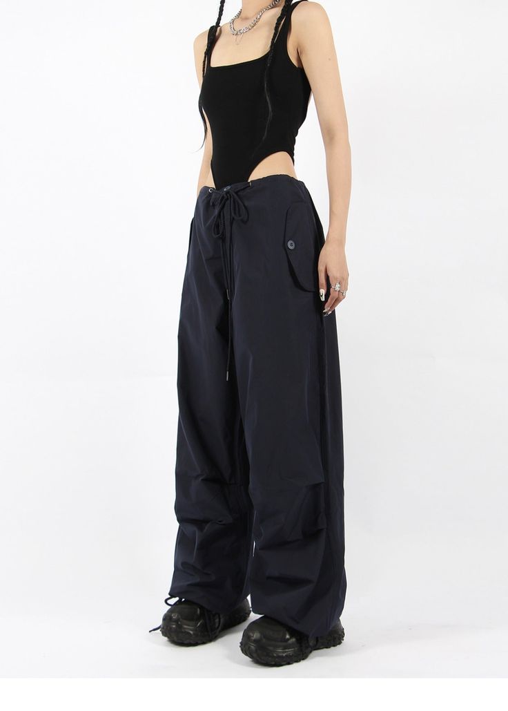 There’s a new trend in town, and it’s nightcity clothing’s Button Pocket Oversized Parachute Pants. These comfy, lightweight pants look great when paired with a crop top or graphic tee and sneakers. With a drawstring waistline, these pants are comfortable and secure, and the oversized fit gives them an effortless and chill look. Add these pants to your wardrobe, and you’ll never have a dull moment — you’ll always be ready for an impromptu night out, no matter how casual it might be.
Gender: Wome Versatile High Waist Parachute Pants With Relaxed Fit, Trendy Pants With Cargo Pockets For Night Out, Trendy Cargo Pocket Pants For Night Out, Chic Baggy Pants For Streetwear, Chic Wide Leg Parachute Pants For Streetwear, Chic Wide-leg Streetwear Bottoms, High Waist Parachute Pants For Spring Night Out, Utility Bottoms With Pockets For Night Out, High Waist Cargo Pants For Summer Night Out