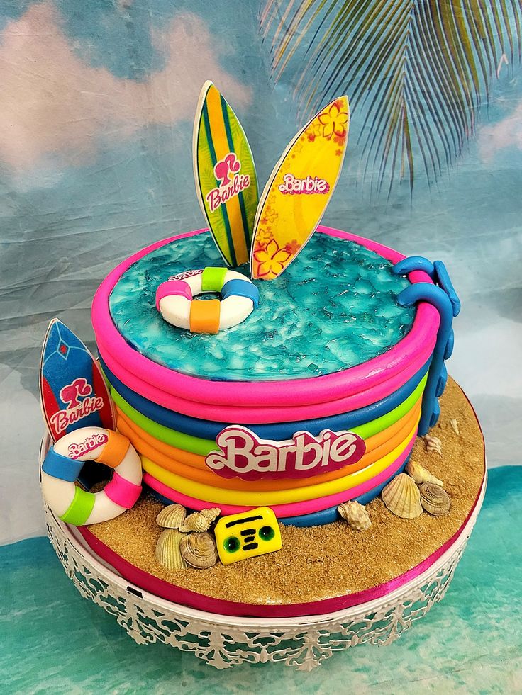 there is a cake made to look like a surfboard on top of the beach