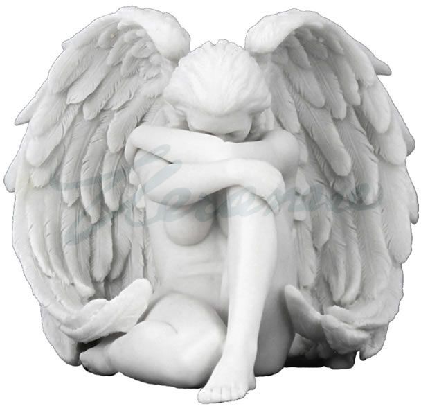 an angel statue sitting on the ground with its arms crossed and legs folded over it's head