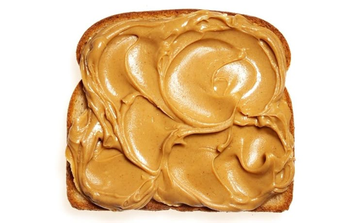 peanut butter spread on top of a piece of bread