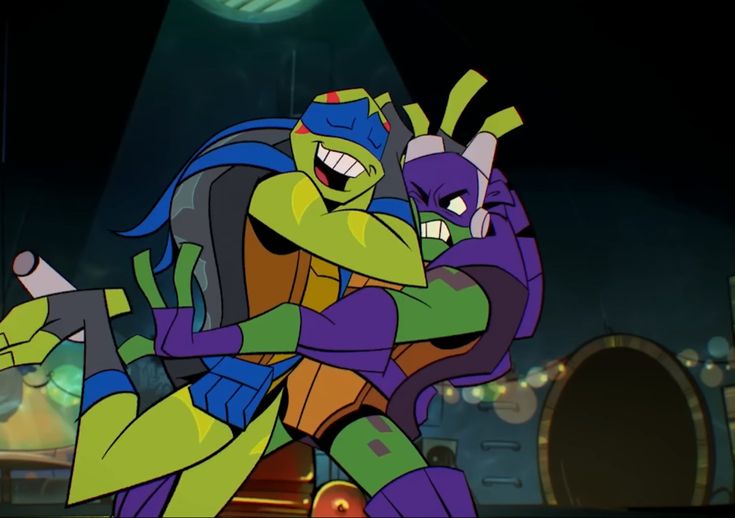 the teenage mutant ninjas are hugging each other in front of a stage with lights