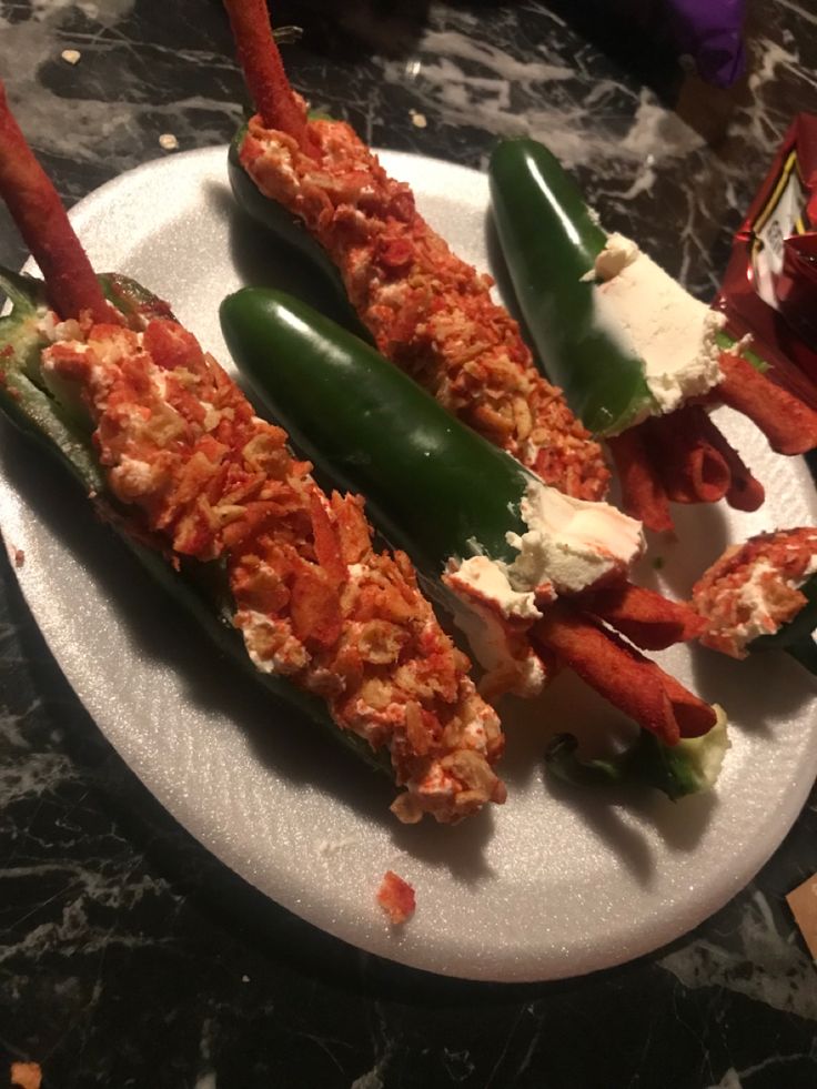 lobster tails stuffed with cheese and vegetables on a plate