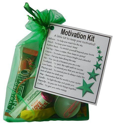 a green bag filled with lots of different items next to a sign that says motivation