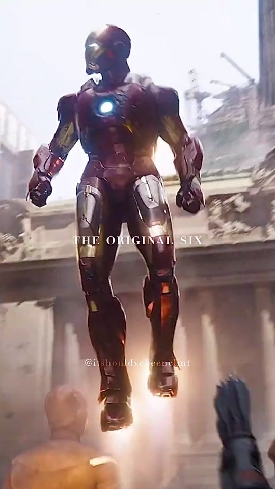 an iron man standing in the air with his hands on his hips and arms outstretched