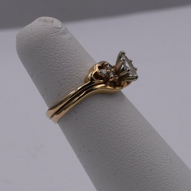 Beautiful 14k Gold Ring With 6 Small Stones and 1 Large Details Size: 3.75 Metal: 14k Gold Weight: 3.07 Grams Gold Bypass Ring With Prong Setting For Wedding, 14k Stamped Marquise Cut Ring For Anniversary, 14k Stamped Round Band Diamond Ring For Anniversary, Stamped 14k Marquise Cut Ring For Anniversary, Stackable Diamond Wedding Rings Stamped 14k, Stamped 14k Diamond Ring For Anniversary With Round Band, 14k Gold Cluster Ring With Vs Clarity For Wedding, 14k Gold Pear-shaped Diamond Promise Ring, Yellow Gold Bypass Ring For Wedding