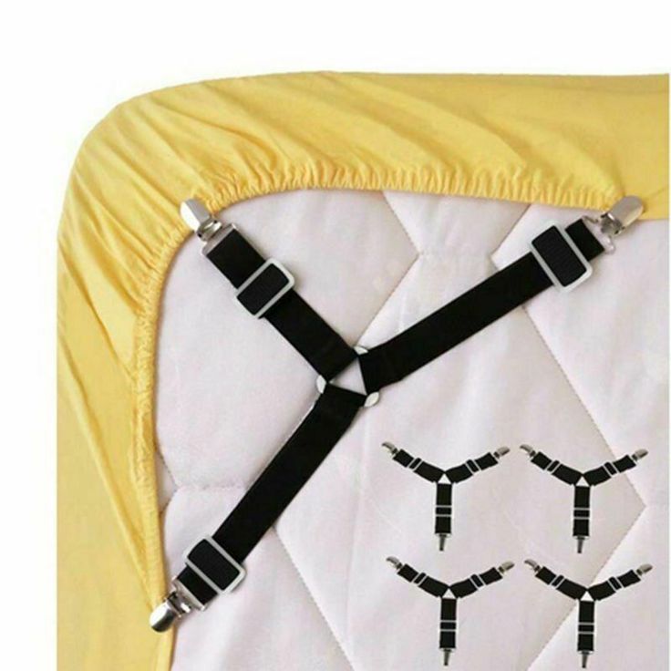 a white quilt with black straps attached to it