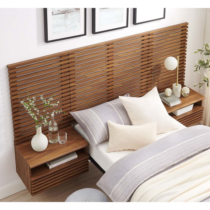 a bed with wooden slats and two vases on the nightstand next to it