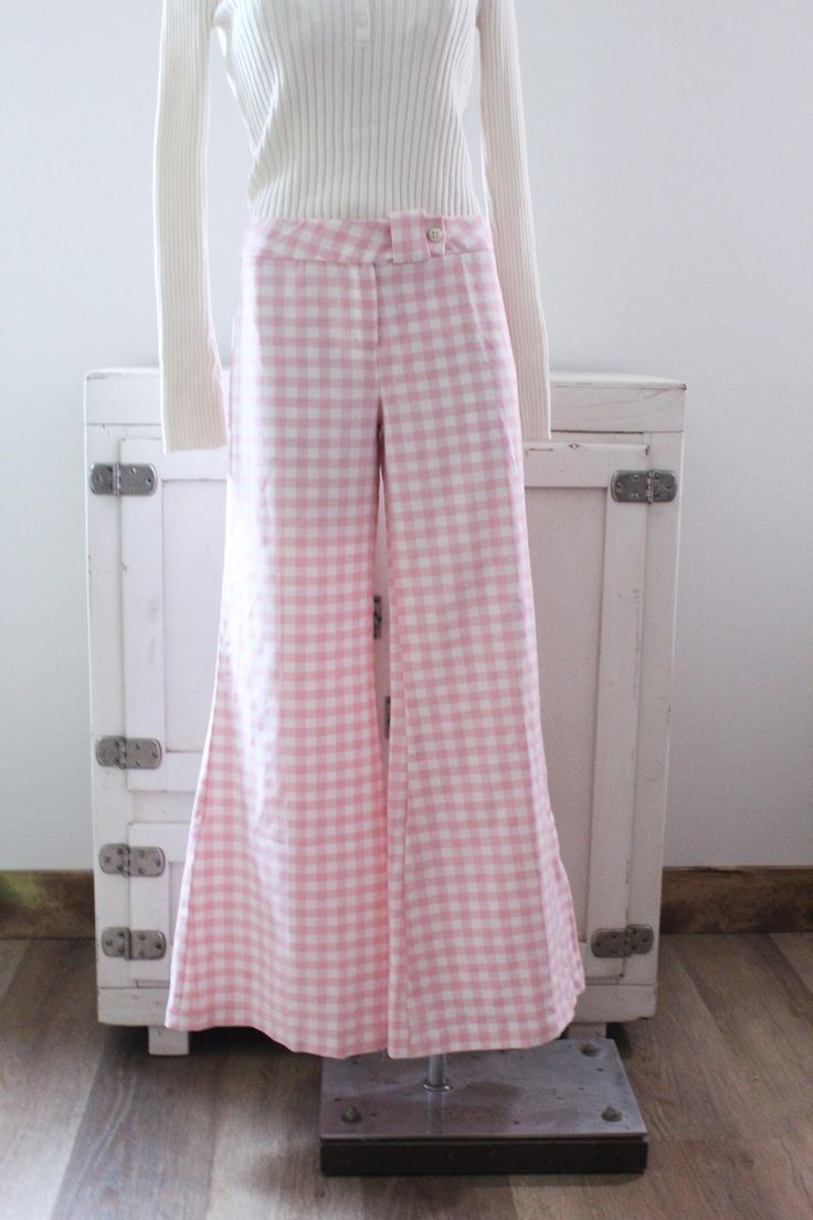 Vintage 70's bell bottom pants.  Pink and white gingham checked.  Wide bells.  Hip huggers.  Button at the waist with a zipper fly.  No pockets. Condition: Good condition.  There is a hole at the bottom of the pants leg, pictured.  A couple tiny spots. Brand: Sears JR Bazaar Fabric: no tag, feels like double knit polyester Measurements: Taken flat, then doubled when necessary. Size: no size tag, probably fits a size medium best Waistband: 33 in. Hips: 44 in. Length: 39 in. Inseam: 31 in. Rise: 1 Plaid Cotton Bottoms For Picnic, Gingham Cotton Pants, Plaid Straight Leg Pants For Spring, Retro Wide Leg Pants With Pockets For Spring, Retro Fitted Wide Leg Pants For Spring, Fitted Retro Wide Leg Pants For Spring, Gingham Cotton Wide Leg Bottoms, Gingham Wide Leg Cotton Bottoms, Summer Plaid Wide-leg Bottoms