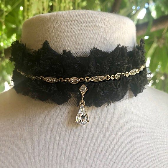 -This very special collection of one-of-a-kind chokers is called Black Dove x Wild Bride.-The designer sourced rare 1920s vintage components to recast and set with genuine Swarovski Crystals, for a timelessly elegant look.  -These beautiful crystal components were then attached to black lace trim with long ties, to make a truly unique choker.-The crystal color is called Crystal Silver Shade, which has an antique appearance.-Total length of the choker from end to end with ribbon ties is 40.5".  L Victorian Choker Necklaces For Party, Antique Choker Necklace For Party, Victorian Style Black Jewelry For Party, Black Victorian Choker Necklace, Victorian Party Choker Necklace, Vintage Teardrop Jewelry For Party, Elegant Black Necklace With Vintage Charm, Elegant Black Necklaces With Vintage Charm, Elegant Adjustable Teardrop Choker