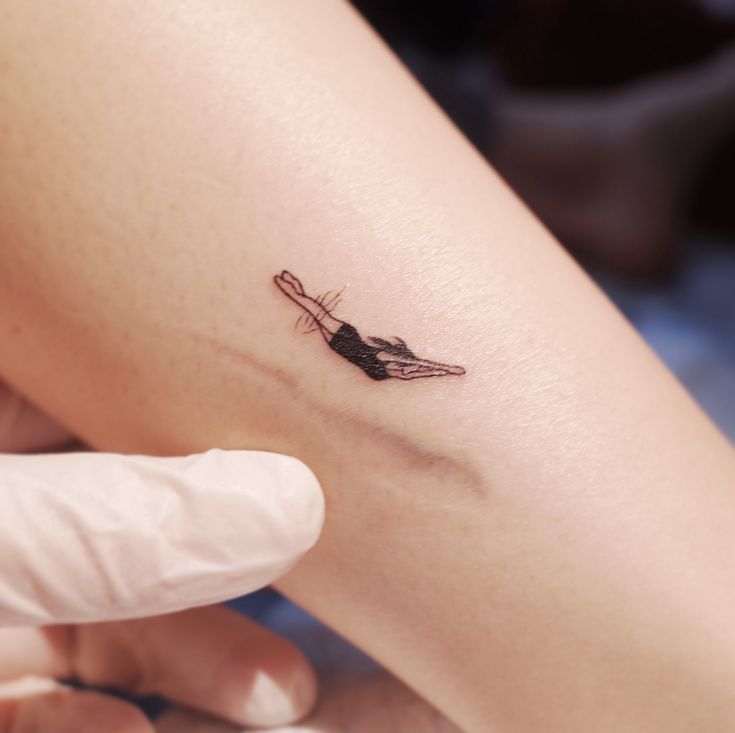 a person with a small tattoo on their arm