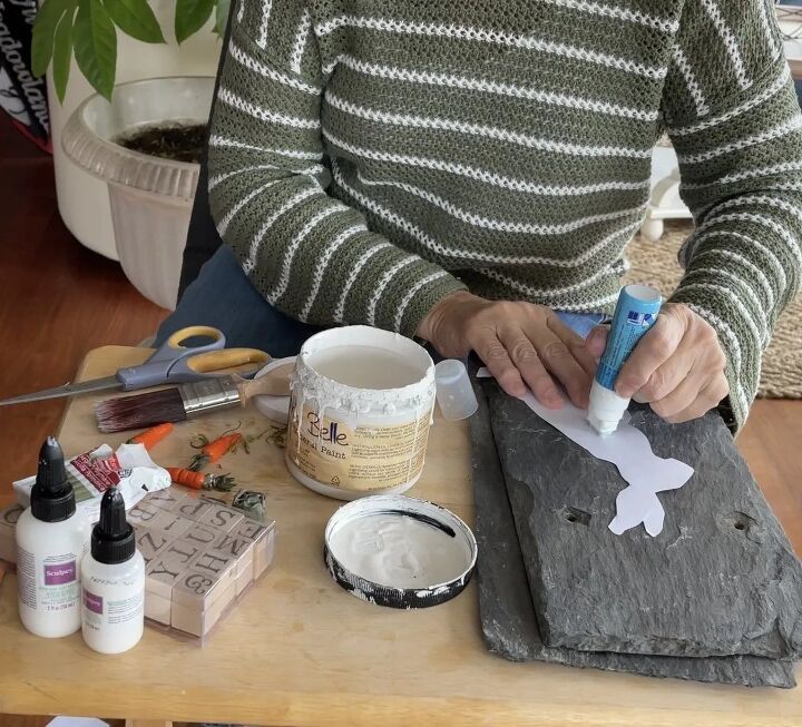 a person sitting at a table with some crafting supplies on top of it,