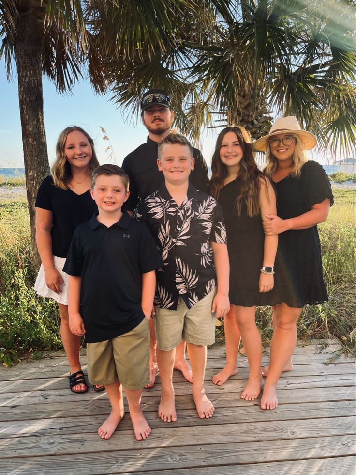 a group of people standing on top of a wooden deck