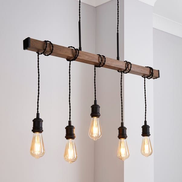 five light bulbs hanging from a wooden beam in a room with white walls and black cords