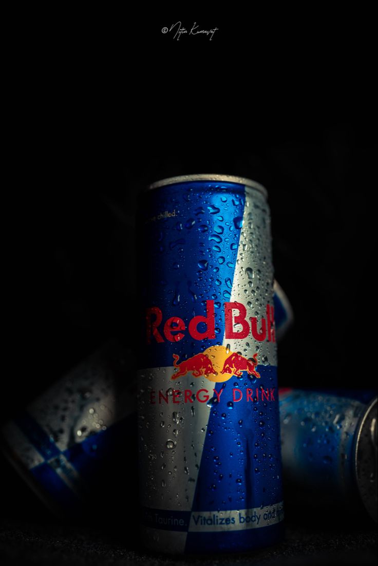 a can of red bull energy drink with water droplets on it