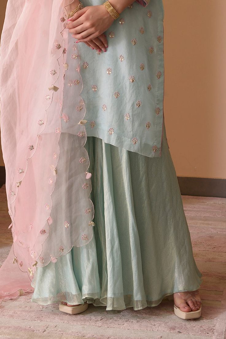 Powder blue floral embroidered kurta in gota work. Paired with striped sharara and dupatta.
Component: 3
Pattern: Hand embroidered
Type Of Work: Thread work, Gota patti
Neckline: Round
Sleeve Type: Three quarter
Fabric: Tissue, Organza
Color: Blue
Other Details: 
Sheer sleeves
Scallop dupatta
Occasion: Haldi, Mehendi - Aza Fashions Scallop Dupatta, Kurta Sharara Set, Kurta Sharara, Gota Work, Sharara Set, Fashion App, Thread Work, Sheer Sleeves, Set For Women