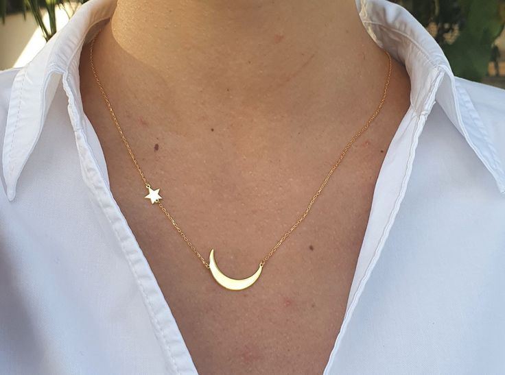 Embrace the magic of the night sky with our Gold Crescent Moon Necklace with Star Pendant. This exquisite piece of celestial jewelry features a delicate crescent moon paired with a shimmering star, symbolizing guidance and hope. Crafted from high-quality materials, this necklace is available in both gold and sterling silver, making it a versatile addition to any jewelry collection. Our moon and star necklace captures the enchanting beauty of the cosmos. The half moon pendant gracefully hangs alongside a sparkling star, creating a timeless design that's perfect for everyday wear or special occasions. Whether you're looking for a moon necklace gold or a moon necklace silver, this piece offers both options to suit your style. This celestial necklace makes an ideal gift for women who appreciat Crescent Moon Necklace Gold, Half Moon Necklace, Moon Necklace Silver, Gold Moon Necklace, Star And Moon, Crescent Moon Pendant, Moon Pendant Necklace, Silver Chain Style, Crescent Moon Necklace