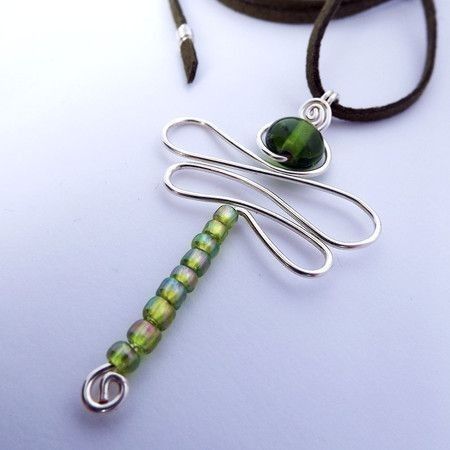 a necklace with a green bead hanging from it's end on a cord