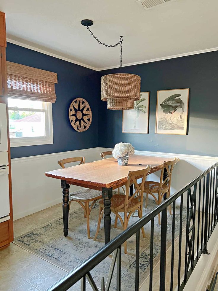 a dinning room table with chairs and pictures on the wall