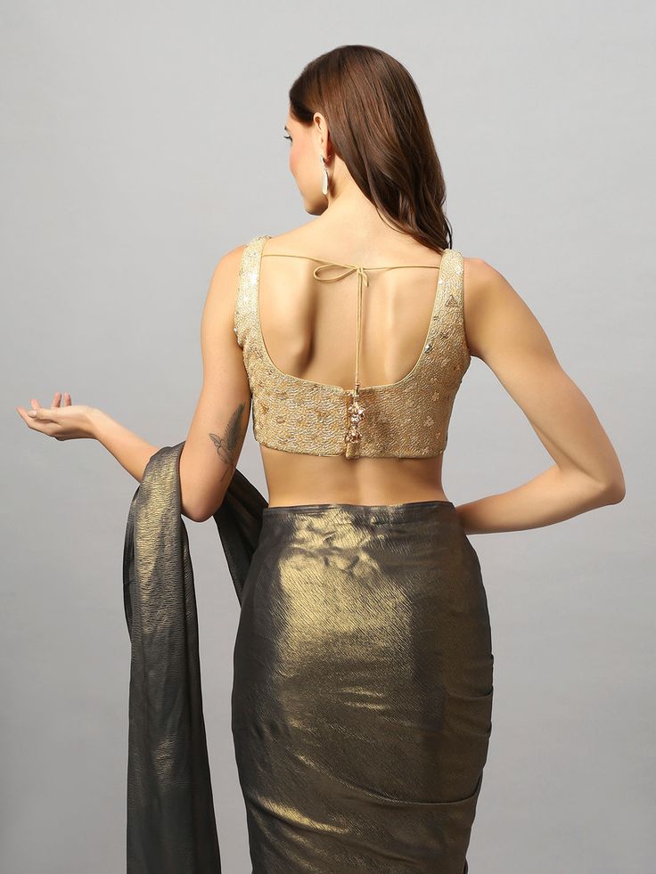 Product Features: Color: Gold Fabric: Net Neck Style: Round Neck Sleeve Length: Sleeveless Closure: Back Padded: Yes Occasion: Festivewear, Casual Product Type: Blouse Disclaimer: There will be slight difference in digital to actual image Festive Sleeveless Crop Top, Fitted Sleeveless Crop Top For Wedding, Gold Sleeveless Padded Blouse Piece, Sleeveless Party Tops, Fitted Sleeveless Vest For Wedding, Festive Sleeveless Wedding Vest, Festive Sleeveless Vest For Wedding, Festive Wedding Sleeveless Vest, Gold Sleeveless Blouse Piece For Party