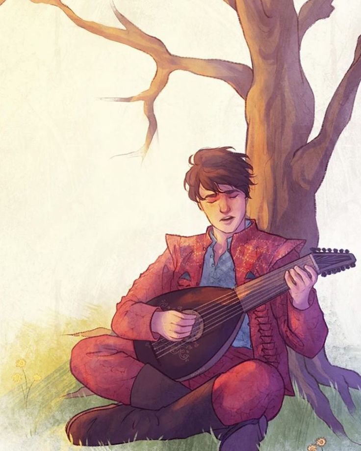 a person sitting under a tree with a guitar